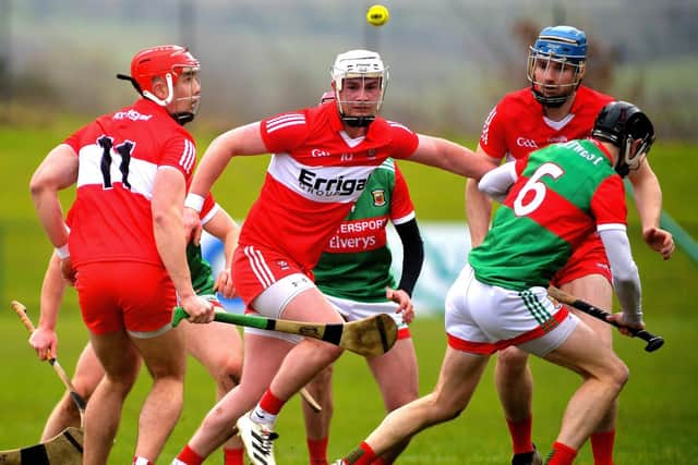 Derry trio John Mullan, Sean Kelly and Brian Gilligan compete with Mayo’s Keith Higgins for the sliothar at Owenbeg on Sunday afternoon last. Photo: George Sweeney. DER2209GS – 005
