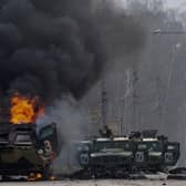 An armoured personnel carrier burns and damaged light utility vehicles stand abandoned after fighting in Kharkiv, Ukraine, Sunday, Feb. 27, 2022. The city authorities said that Ukrainian forces engaged in fighting with Russian troops that entered the country's second-largest city on Sunday. (AP Photo/Marienko Andrew)