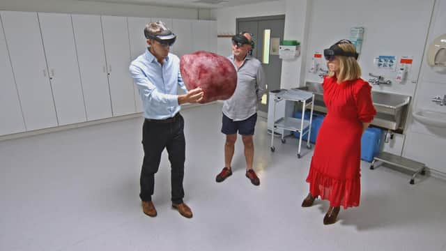 Adrian, Dr Nick Burfitt and Kate Garraway looking at an enlarged prostate GFX in studio
