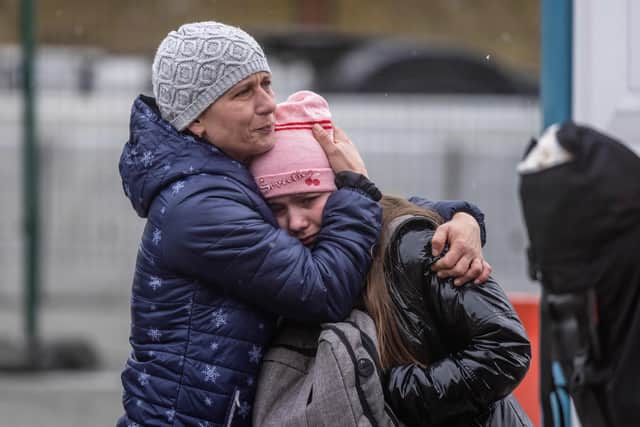 An Ukrainian woman huggs her daughter after acrossing the Ukrainian-Polish border in Korczowa on March 02, 2022. - The number of refugees fleeing the conflict in Ukraine has surged to nearly 875,000, UN figures showed on on March 2, as fighting intensified on day seven of Russia's invasion. (Photo by Wojtek RADWANSKI / AFP) (Photo by WOJTEK RADWANSKI/AFP via Getty Images)