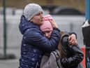 An Ukrainian woman huggs her daughter after acrossing the Ukrainian-Polish border in Korczowa on March 02, 2022. - The number of refugees fleeing the conflict in Ukraine has surged to nearly 875,000, UN figures showed on on March 2, as fighting intensified on day seven of Russia's invasion. (Photo by Wojtek RADWANSKI / AFP) (Photo by WOJTEK RADWANSKI/AFP via Getty Images)