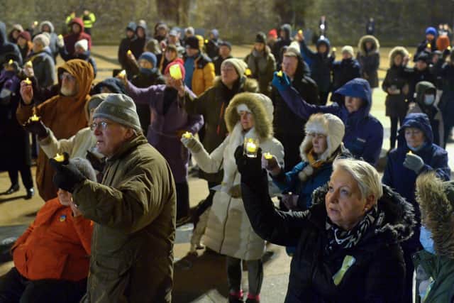People gather in Guildhall Square on Wednesday evening last during a candle-lit vigil in solidarity with the people of Ukraine.  Photo: George Sweeney.  DER2209GS – 034