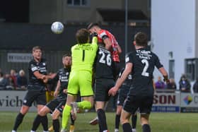 Eoin Toal rises highest to meet Will Patching's corner but Sligo keeper Ed McGinty gets a touch to turn his header behind.