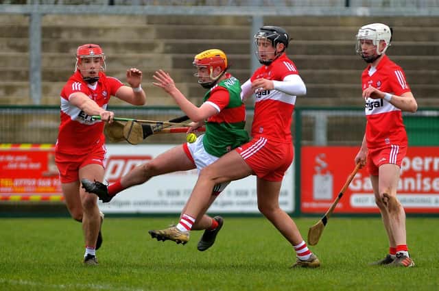 Derry ‘s John Mullan and Meehaul McGrath battle for possession with Mayo’s Conor Murray at Owenbeg last Sunday. Photo: George Sweeney. DER2209GS – 003