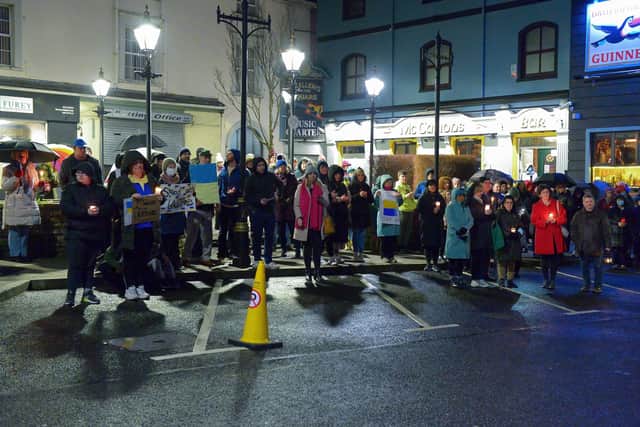 People gather in Market Square in Buncrana on Thursday evening last for prayers and a candle-lit vigil in solidarity with the people of Ukraine.  Photo: George Sweeney.  DER2209GS – 051