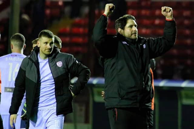 Derry City boss Ruaidhri Higgins celebrates his side's 'professional' win over Shelbourne at Tolka Park with the travelling support as matchwinner Patrick McEleney looks on. Photo by Kevin Moore.
