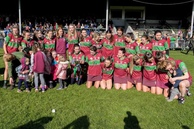The Eoghan Rua team celebrate after the game with the trophy after the AIB All-Ireland Junior Club Camogie Championship Final in Drogheda against Clanmaurice.  
(Photo: INPHO/Cathal McOscar)