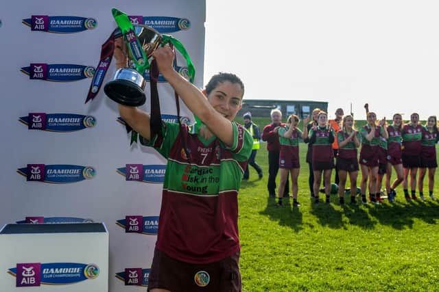 Eoghan Rua's Ellis McNamee lifts the trophy after Saturday's AIB All-Ireland Junior Club Camogie Championship Final against Clanmaurice. (INPHO/Cathal McOscar)