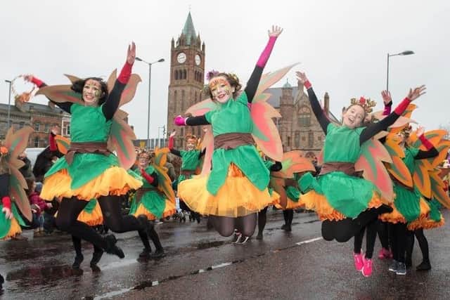 Dancers from St. Cecilia's College leap in the air as they make their way past the Guildhall during the annual Spring Carnival on St. Patrick’s Day in Derry in 2017. Picture Martin McKeown. Inpresspics.com. 17.03.17