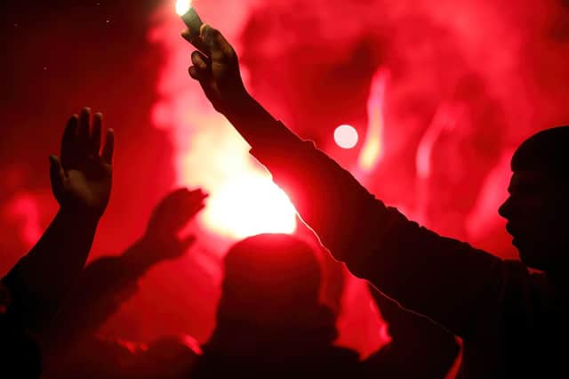 Derry City fans set off flares during a recent game. Photograph by Kevin Moore.
