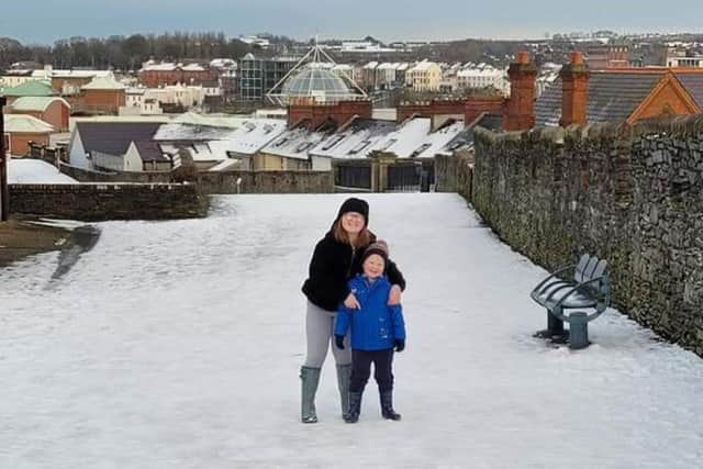 Lillie-Mae with her little brother walking the snow-covered walls.