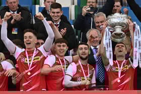 Cliftonville's Ryan Curran, Paul O'Neill and Jamie McDonagh celebrate as captain Chris Curran lifts the Bet McLean League Cup aloft. Picture by Colm Lenaghan/Pacemaker