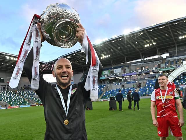 Cliftonville boss Paddy McLaughlin shows off the trophy to Reds supporters. Picture by Colm Lenaghan/Pacemaker