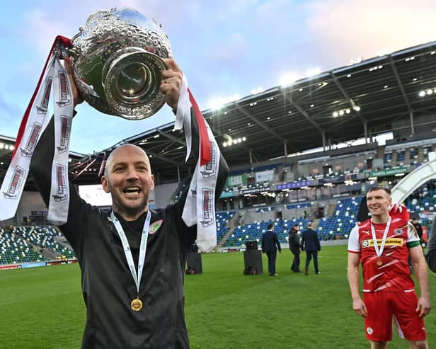 Cliftonville boss Paddy McLaughlin shows off the trophy to Reds supporters. Picture by Colm Lenaghan/Pacemaker