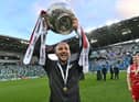 Cliftonville boss Paddy McLaughlin shows off the trophy to Reds supporters. Picture by Colm Lenaghan/Pacemaker