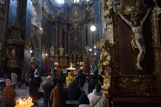 Ukrainian Catholic faithfuls pray during a service at the Saints Peter and Paul Garrison Church in the western Ukrainian city of Lviv on March 7, 2022, 12 days after Russia launched a military invasion on Ukraine. (Photo by Yuriy Dyachyshyn / AFP) (Photo by YURIY DYACHYSHYN/AFP via Getty Images)