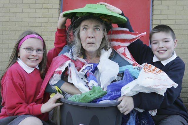BIN THE BAG - Lisnagelvin Primary School pupils Laura Tompson and Aaron Feathers join the Bag Lady (Shirley Lewis) when she visited schools this week to promote the new Derry City Council campaign to encourage people to use shopping bags not plastic bags. (0704C50)
