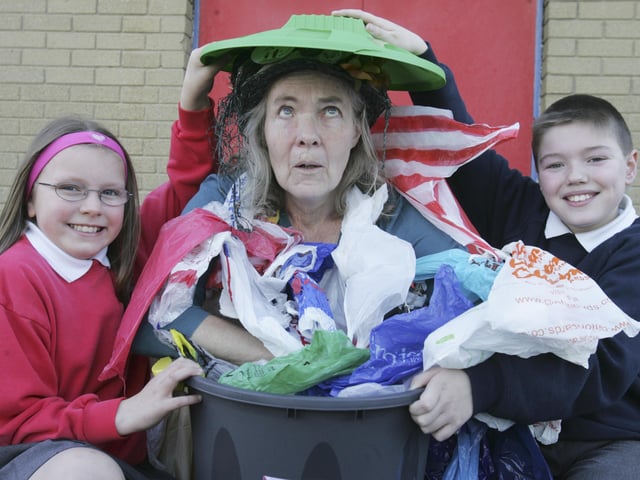 BIN THE BAG - Lisnagelvin Primary School pupils Laura Tompson and Aaron Feathers join the Bag Lady (Shirley Lewis) when she visited schools this week to promote the new Derry City Council campaign to encourage people to use shopping bags not plastic bags. (0704C50)
