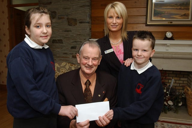 Abbie McCurdy and Jeff Greer from Lisnagelvin Primary School, present the Foyle Hospice with a cheque for £1000, money raised at a Christmas concert at the school. Included are Dr Tom McGinley, Foyle Hospice director, and Andrena Arbuckle. administration. (2001PG19)