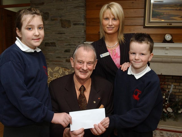Abbie McCurdy and Jeff Greer from Lisnagelvin Primary School, present the Foyle Hospice with a cheque for £1000, money raised at a Christmas concert at the school. Included are Dr Tom McGinley, Foyle Hospice director, and Andrena Arbuckle. administration. (2001PG19)