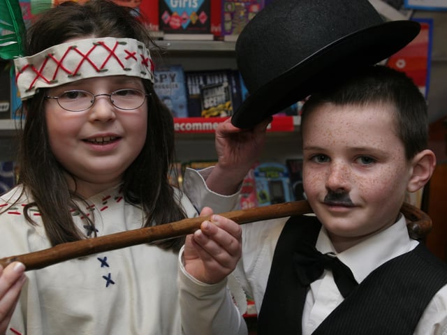 Dressed in character from story books are pupils Chloe Black, as 'Pochantas' and Jordon McMullan, as Charlie Chaplan, at the storytelling day at Lisnagelvin primary school, organised as part of the school's 'Book Day' event. (2802T07).