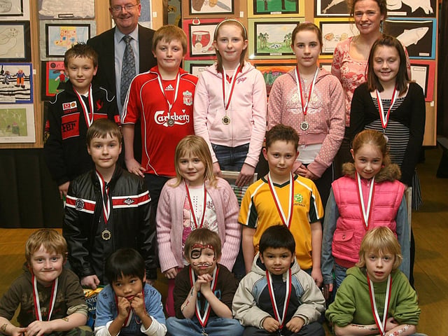 Pupils who received prises at a Lisnagelvin Primary School’s art competition and exhibition held at the school. From left (front row), Ruairi McDowell, Joshua Ferris, Daniel Kane, Bashar Khan and Steven McCandless. Adam Feathers, Melissa Hanna, Ronan Stainthorpe and Sara Douglas.  Back row, Rhys Donaghey, Ross Hetherington, Hannah Lecky, Laura Smallwoods and Laura Boyd. Included are William McIlwaine, principal and Martina Gardiner, PTA chairperson. (0502T03).