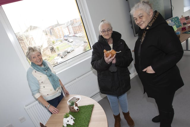 Cathedral Youth Club director Jeanette Warke showing off some of the artwork produced by the young people at the club to Siobhan Guille and Maria Arbuckle.