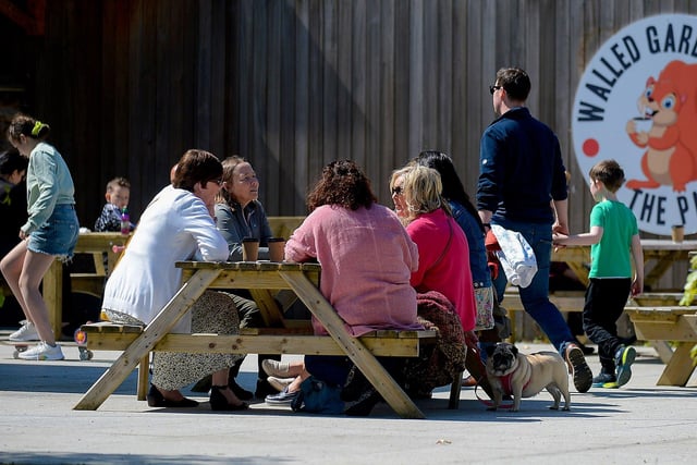 Customers enjoy a coffee in the sunshine, at St Columb’s House cafe, in St Columb’s Park. DER2120GS – 012
