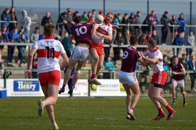 Derry's Conor Glass contests a high ball with Galway's Matthew Tierney in Owenbeg today (Photo: George Sweeney)