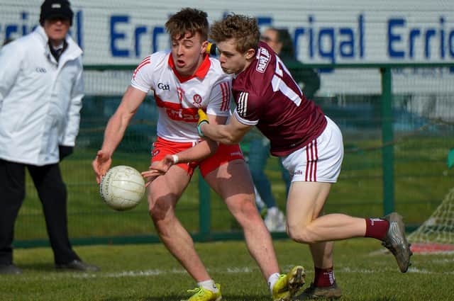 Derry’s Oisin McWilliams fights off a challenge from Galway’s Johnny McGrath at Owenbeg on Sunday afternoon last. DER2212GS – 007 (Photo: George Sweeney)