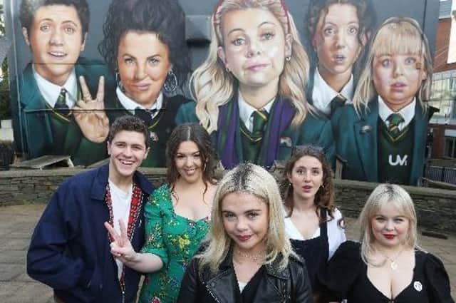 The cast of Derry Girls with Lisa McGee at the Derry Girls mural at Badger's.