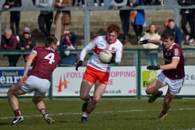 Derry’s Lachlan Murray evades a challenge from Galway’s Liam Silke and Paul Kelly at Owenbeg on Sunday. Photo: George Sweeney. DER2212GS – 002