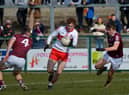 Derry’s Lachlan Murray evades a challenge from Galway’s Liam Silke and Paul Kelly at Owenbeg on Sunday. Photo: George Sweeney. DER2212GS – 002