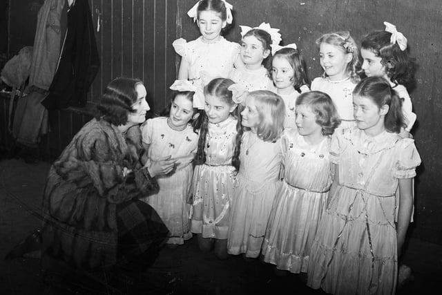 1952... The fairies in the pantomime 'Sinbad the Sailor' which ran at St Patrick's Hall, Spencer Road, receive a final word of advice from their director, Mrs F Fitzpatrick, before taking to the stage. The fairies are, front, from left, Deirdre Friel, Dolores McGilloway, Ursula Fitzpatrick, Irene Cauley and Kathleen Cauley. At back are Josephine Crilly, Roisin Jordan, Josephine Fitzpatrick, Pauline Given and Kathleen Hone.