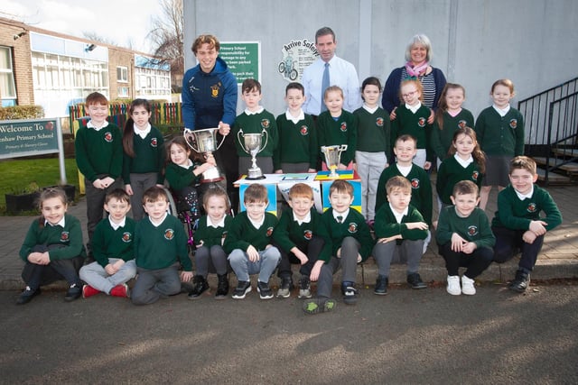 Primary 3 pupils at Greenhaw Primary School with Brian Ogs player Donncha Gilmore and the trophies won this season by the local club.  (Photos: Jim McCafferty Photography)