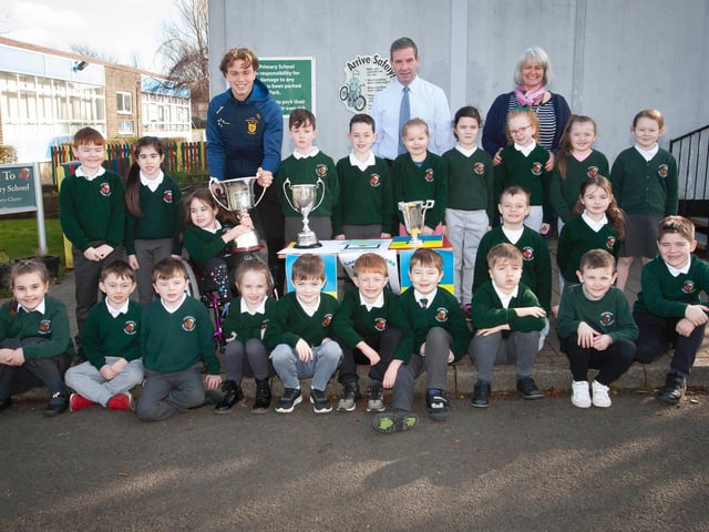 Primary 3 pupils at Greenhaw Primary School with Brian Ogs player Donncha Gilmore and the trophies won this season by the local club. (Photos: Jim McCafferty Photography)