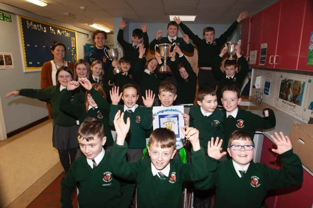 Primary 7 pupils at Greenhaw Primary School celebrate the visit of the Steelstown Brian Ogs' Donnacha Gilmore with the All Ireland Intermediate trophy. (Photo: Jim McCafferty)