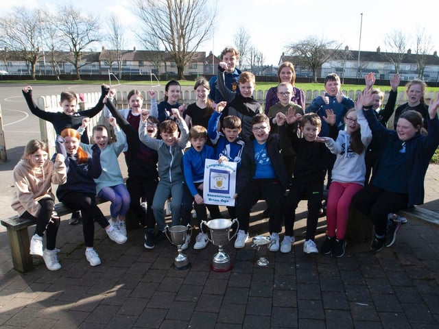 Primary 7 pupils at Greenhaw PS celebrate the visit of the Steelstown player Donnacha Gilmore with the Derry, Ulster and All Ireland winning trophies recently. (Photo: Jim McCafferty)
