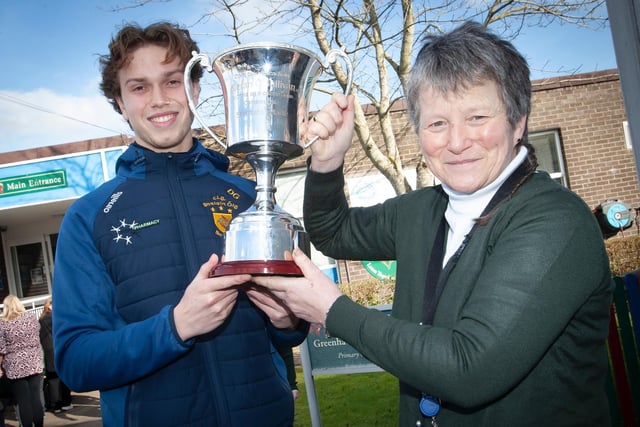 Ms. Heaney pictured with Steelstown Brian Ogs player and school coach, Donncha Gilmore and the All-Ireland trophy during the recent visit. (Photo: Jim McCafferty)