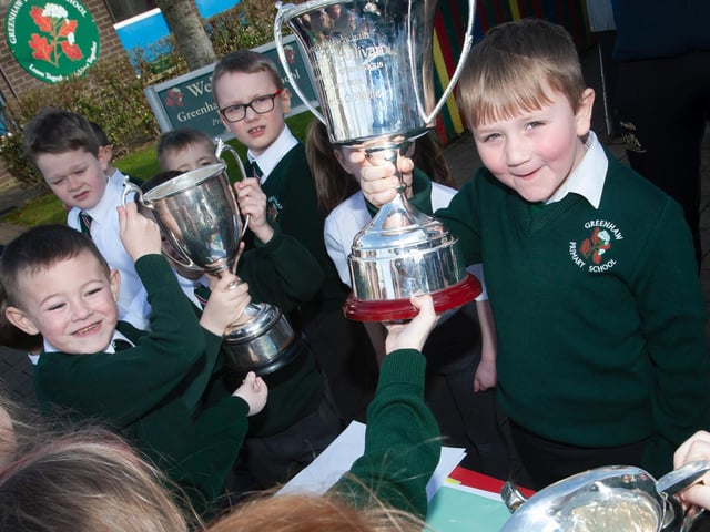 Some of the younger pupils get a chance to get their hands on the trophies who by Steelstown Brian Ogs last season during the recent visit (Photo: Jim McCafferty)