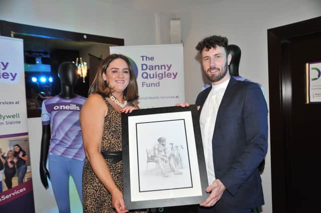 Aisling Hutton, BBHF, presenting Danny Quigley with a drawing by Derry's Dave Campbell.