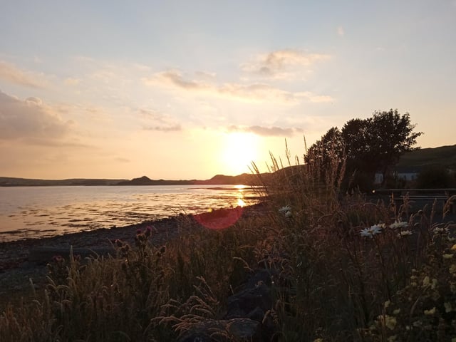 Watch the sun set from the picnic areas a mile or so beyond Malin Town.