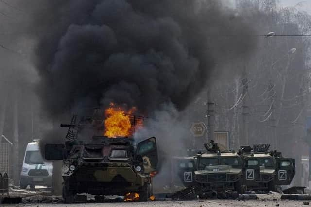 Russian personnel carriers in flames in Kiev.