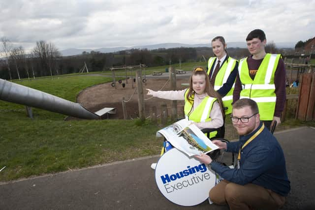 Mischa showing the Housing Executive's Matthew McCay, Rural and Regeneration Unit where the proposed changes for inclusive play equipment for young people with disabilities will be installed in Strathfoyle Play Park.Included are fellow volunteers Holly Hunter and Kaid Callaghan.