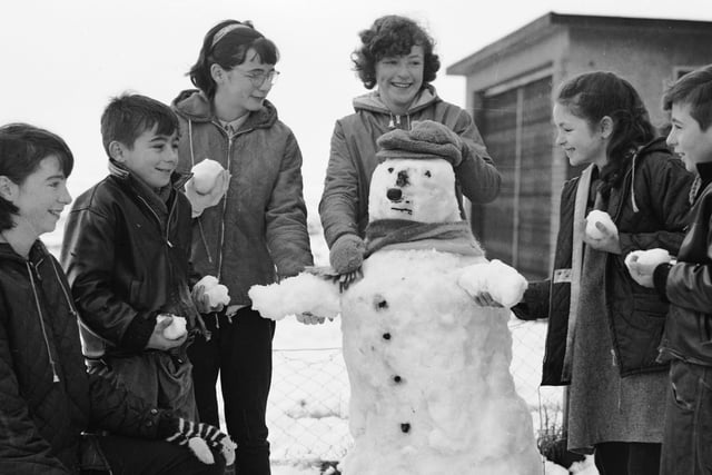 Nov 1965. A weekend blizzard brought pleasure for the young folk. This snowman was built in the garden of the Crossan family at Circular Road, Creggan.