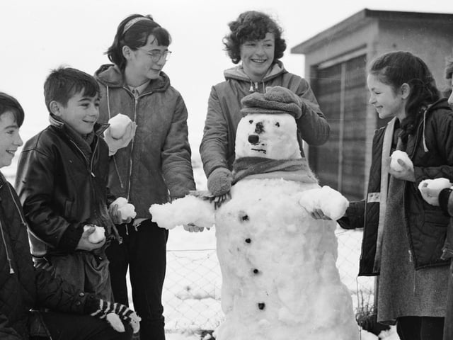 Nov 1965. A weekend blizzard brought pleasure for the young folk. This snowman was built in the garden of the Crossan family at Circular Road, Creggan.