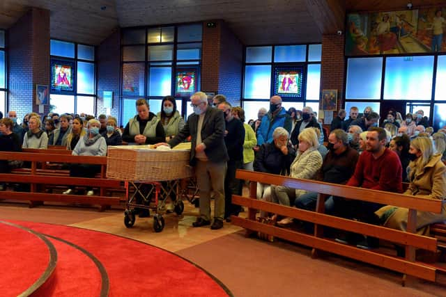 Local people pay their respect at the coffin of Ballymagroarty Parish Priest Fr. Paddy O’Kane in Holy Family Church on Tuesday evening. Photograph: George Sweeney / Derry Journal. DER2213GS – 001