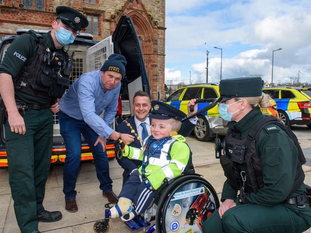 Jack Beattie from Donegal who has Osteogenesis Imperfacta or Brittle Bone Disease pictured during a reception held for him by Alderman Graham Warke, Mayor of Derry City and Strabane District Council. The honorary Garda also met with members of the PSNI who presented him with a certificate of recognition and the PSNI crest. Jack also made his first arrest in the North when he put the handcuffs on his dad Kevin.  Picture Martin McKeown. 30.03.22