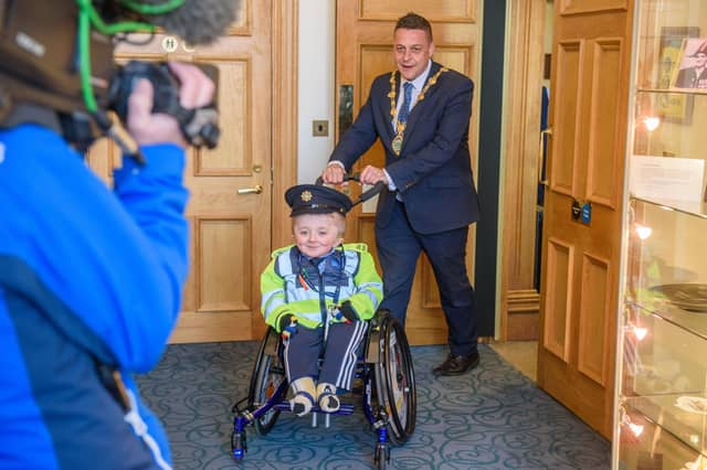 Jack Beattie from Donegal who has Osteogenesis Imperfacta or Brittle Bone Disease pictured during a reception held for him by Alderman Graham Warke, Mayor of Derry City and Strabane District Council. The honorary Garda also met with members of the PSNI who presented him with a certificate of recognition and the PSNI crest. Jack also made his first arrest in the North when he put the handcuffs on his dad Kevin. Picture Martin McKeown. 30.03.22