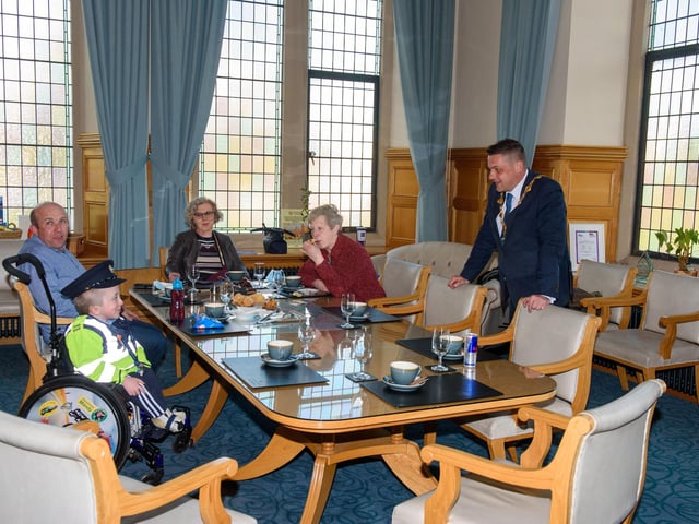 Jack Beattie from Donegal who has Osteogenesis Imperfacta or Brittle Bone Disease pictured during a reception held for him by Alderman Graham Warke, Mayor of Derry City and Strabane District Council. The honorary Garda also met with members of the PSNI who presented him with a certificate of recognition and the PSNI crest. Jack also made his first arrest in the North when he put the handcuffs on his dad Kevin.  Picture Martin McKeown. 30.03.22